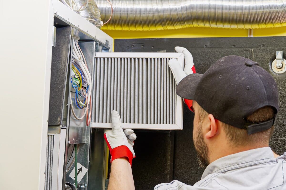 Technician performing HVAC maintenance