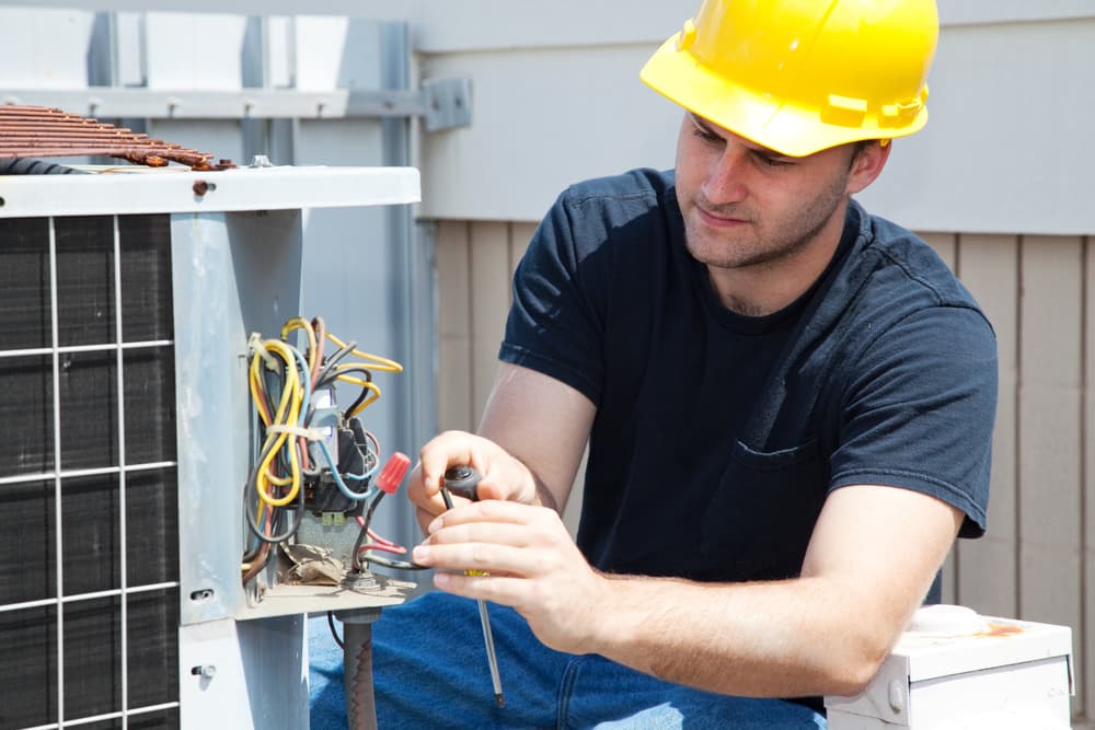 Technician servicing an air conditioner